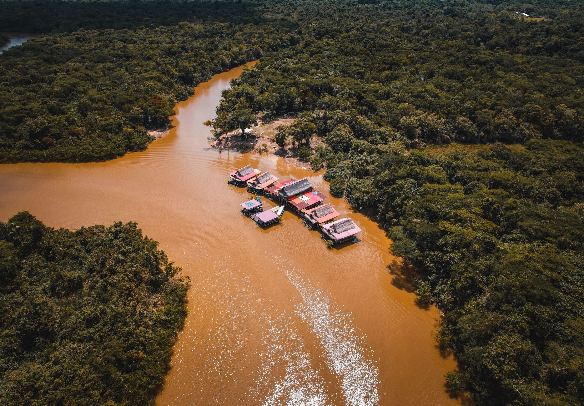Aerial view of an Amazon River village surrounded by Peruvian rainforest